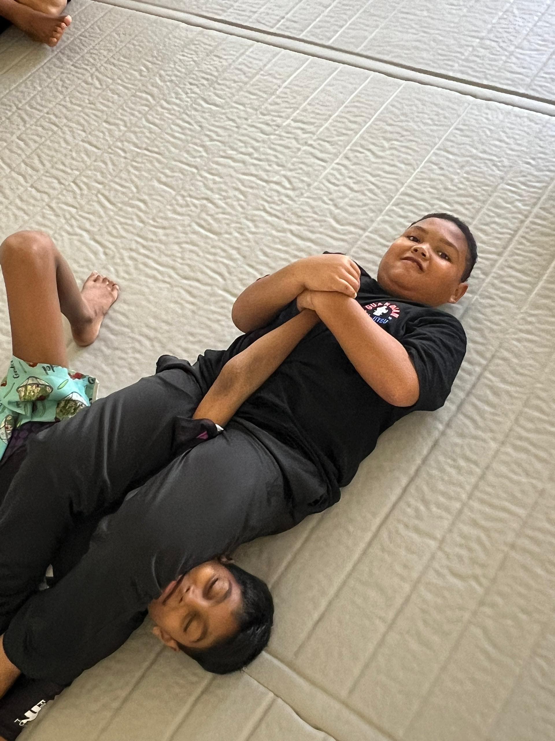 Students building resilience and testing their skills on the mat.